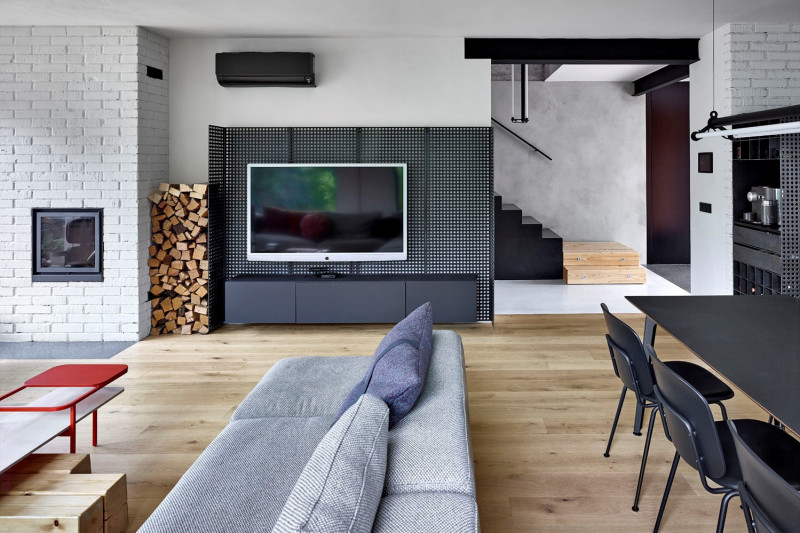 Také stěna za televizí je ze surového ocelového plechu, do kterého bylo laserem vyřezáno perforování, aby velkoplošný prvek nepůsobil příliš masivně